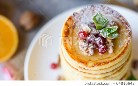 Delicious fresh beautiful pancakes with citrus Delicious fresh beautiful pancakes with citrus 64816642