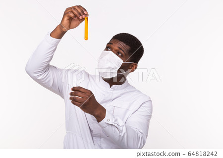 Glass tube with yellow fluid in doctor hand during medical test. Vaccine development, experiments and science concept. 64818242