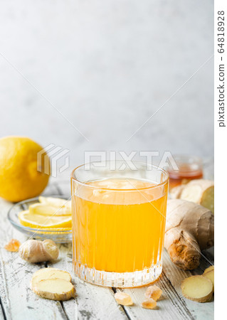 Yellow drink ginger and ice 64818928