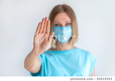 Attractive female nurse showing stop sign with his 64819341