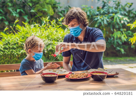 Father and son using wash hand sanitizer gel before eating in a cafe Tourists fear the 2019-ncov 64820181