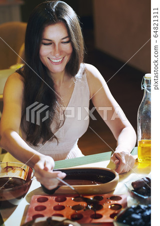 Staying at home woman preparing handmade 64821311