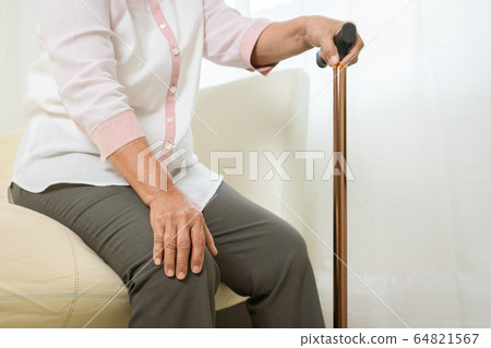 Knee pain of senior woman with stick, healthcare problem of senior concept 64821567