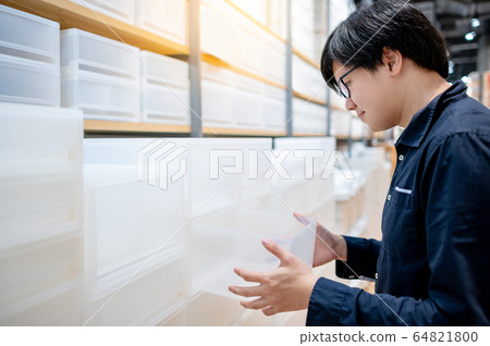 Asian man choosing plastic box drawer in furniture Asian man choosing plastic box drawer in furniture 64821800