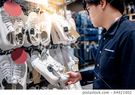 Asian man customer choosing white sneakers in Asian man customer choosing white sneakers in 64821802