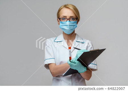medical doctor nurse woman wearing protective mask and gloves - holding virus blood test and plane table medical doctor nurse woman wearing protective mask and gloves - holding virus blood test and plane table 64822007
