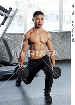 Shirtless strong sportsman doing lunge Shirtless strong sportsman doing lunge 64822506