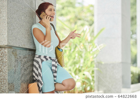 Young woman calling friend Young woman calling friend 64822668