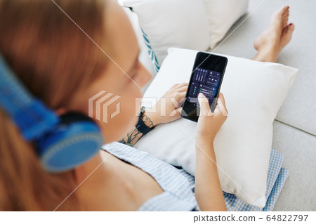 Woman setting volume via app 64822797