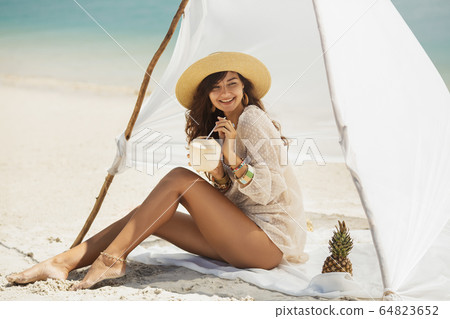 Woman Resting on the Beach During Vacation Woman Resting on the Beach During Vacation 64823652