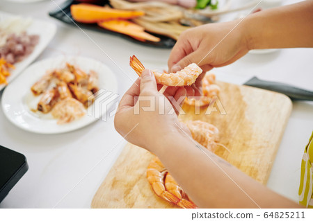 Woman making seafood salad Woman making seafood salad 64825211