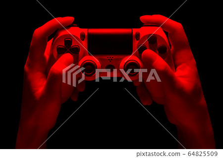 Hyman hands holding white video game gamepad in 64825509