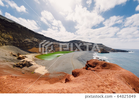 Volcanic crater with green lake and ocean in El Golfo, Lanzarote, Spain. Volcanic crater with green lake and ocean in El Golfo, Lanzarote, Spain. 64825849