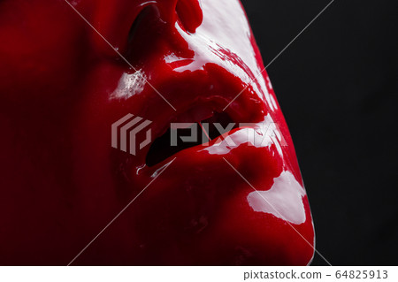 Photo of woman's lips with red paint 64825913