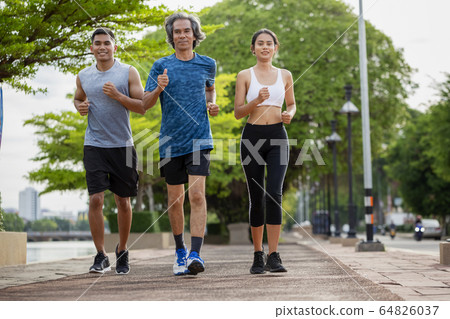 Family exercising and jogging together  64826037