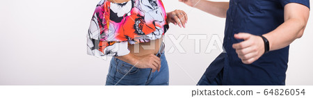 Couple dancing latin music. Bachata, merengue, salsa and kizomba. Close-up of elegance pose on white room. Couple dancing latin music. Bachata, merengue, salsa and kizomba. Close-up of elegance pose on white room. 64826054