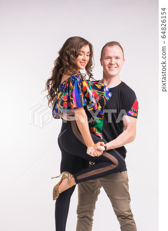 Funny couple dancing social dance. Kizomba or bachata or semba or taraxia , on white background. Social dance concept. 64826154