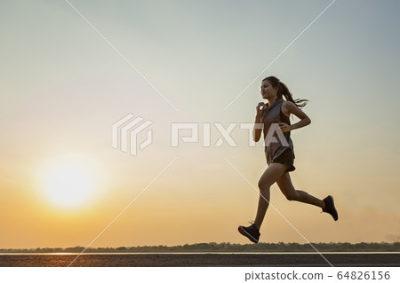 The silhouette of young women running  64826156