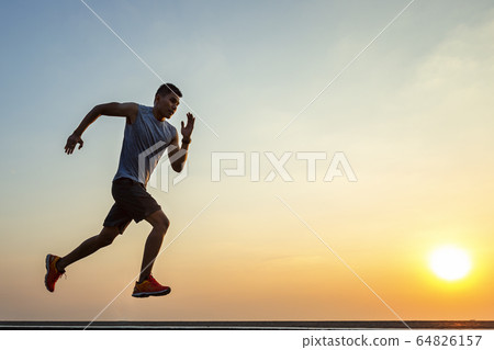 The silhouette of young men running and exercising 64826157