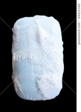 bar of soap with foam bubbles on black background. 64826388