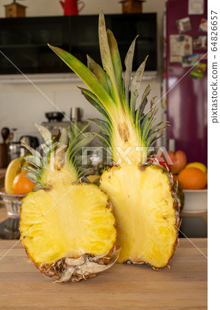 Close-up view of two halve pineapple fruit on a Close-up view of two halve pineapple fruit on a 64826657