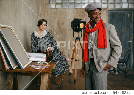 Portrait painter and female model in art studio Portrait painter and female model in art studio 64828252
