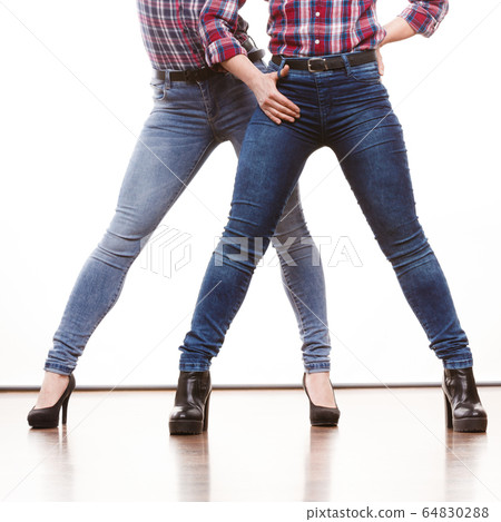 Female legs in denim pants heeled shoes Female legs in denim pants heeled shoes 64830288
