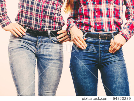 Two women in jeans pants. 64830289