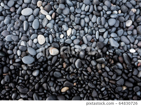 Gray pebbles as a background in the Iceland sea shore. Abstract composition. Gray pebbles as a background in the Iceland sea shore. Abstract composition. 64830726