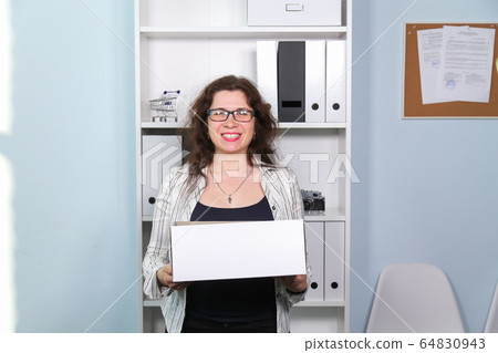 Concept of dismissal from work. Happy woman with carton box with her stationery stuff, girl was fired from her job. Concept of dismissal from work. Happy woman with carton box with her stationery stuff, girl was fired from her job. 64830943