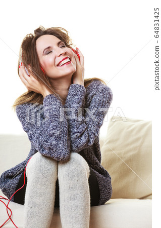 Woman with headphones listening music 64831425