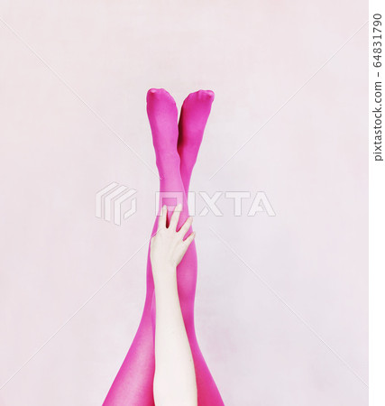 Female legs wearing pink tights Female legs wearing pink tights 64831790