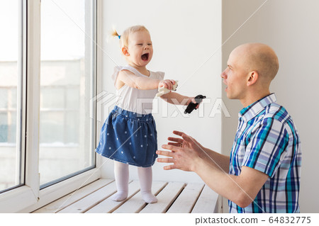 Father with his cheerful baby girl daughter. Single parent. Fatherhood, father's day and family concept. 64832775