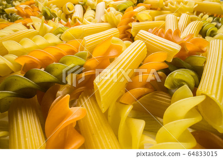 Variety of types and shapes of dry Italian pasta close-up. Food and traditional cuisine. Variety of types and shapes of dry Italian pasta close-up. Food and traditional cuisine. 64833015