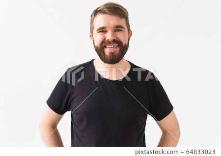 Cheerful guy smiled happily, has excited expression over white studio background. Holidays, youth, emotions concept. Cheerful guy smiled happily, has excited expression over white studio background. Holidays, youth, emotions concept. 64833023