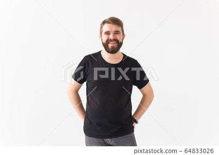 Cheerful guy smiled happily, has excited expression over white studio background. Holidays, youth, emotions concept. 64833026