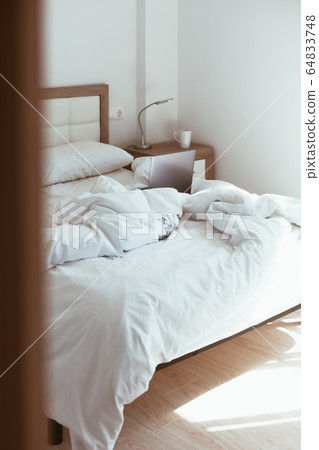 Working home isolation concept. Laptop in bed Working home isolation concept. Laptop in bed 64833748