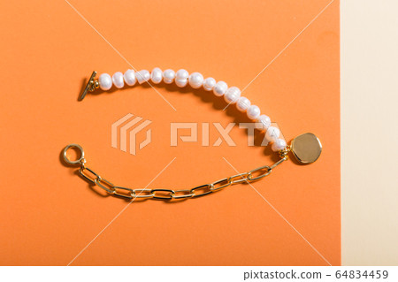 Top view of fashion jewelry and accessories on bright color background. Luxurious jewelry bijouterie and trendy concept. Top view of fashion jewelry and accessories on bright color background. Luxurious jewelry bijouterie and trendy concept. 64834459