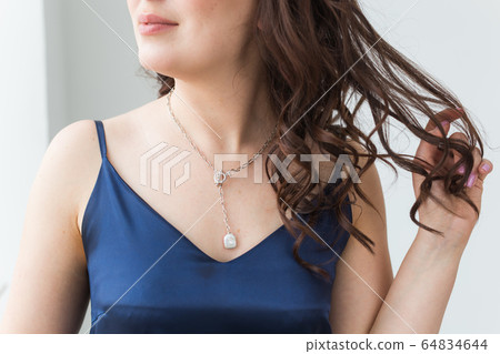 Close-up portrait of beautiful young woman with elegant hairstyle and luxurious jewelry and bijouterie. Close-up portrait of beautiful young woman with elegant hairstyle and luxurious jewelry and bijouterie. 64834644