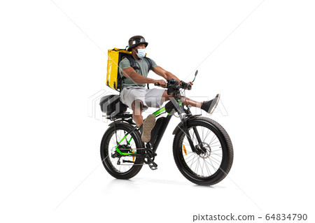 Too much orders. Contacless delivery service during quarantine. Man delivers food and shopping bags during isolation, wearing helmet and face mask. Too much orders. Contacless delivery service during quarantine. Man delivers food and shopping bags during isolation, wearing helmet and face mask. 64834790