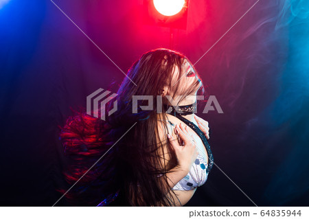Young woman dancing in Tribal Fusion style. Belly dance on the stage. 64835944