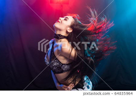 Young woman dancing in Tribal Fusion style. Belly dance on the stage. Young woman dancing in Tribal Fusion style. Belly dance on the stage. 64835964