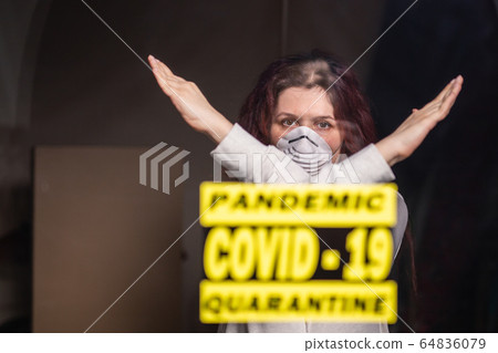 Woman in respiratory mask showing stop gesture. Girl show gesture no. Stop coronavirus or covid-19 and the pandemic. Stay home. Quarantine concept. 64836079