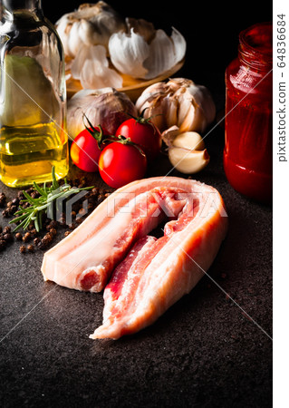 raw pork belly with garlics, tomatoes, 64836684