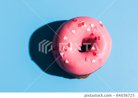 Trendy sunlight. Doughnut on bright light blue turquoise background. Minimal summer concept. Pop art style. Trendy sunlight. Doughnut on bright light blue turquoise background. Minimal summer concept. Pop art style. 64836725