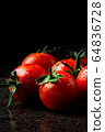 fresh tomatoes with wet and droplet on black stone 64836728