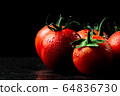 fresh tomatoes with wet and droplet on black stone 64836730