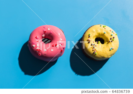 Trendy sunlight. Summer doughnuts on bright light blue turquoise background. Minimal summer concept. Pop art style. Donut 64836739