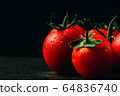 fresh tomatoes with wet and droplet on black stone 64836740