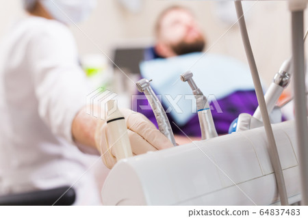 Dental tool equipment in stomatology clinic. Dentistry and dental health concept. 64837483